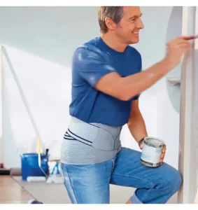 Man painting his house while weaing a lumbar support belt