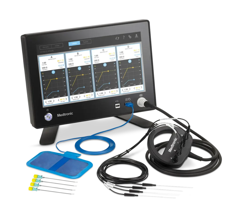 A radiofrequency ablation machine made by Medtronic. The machine is connected to the probe hub and the ablation probes, needles, and grounding pad are displayed in front of the machine